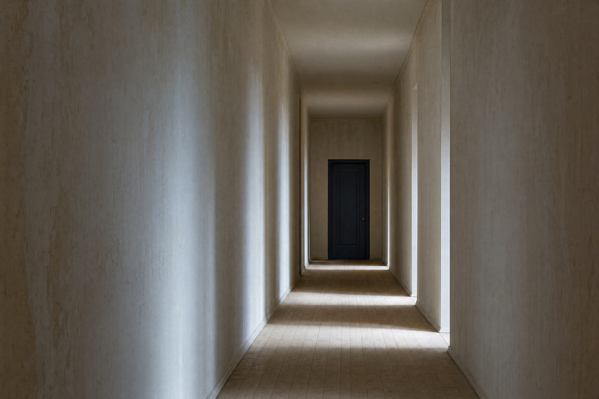 A quiet corridor leading to a navy painted door
