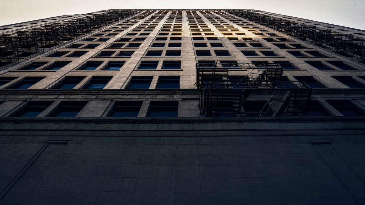 Stone facade of a New York building photographed looking up toward the sky